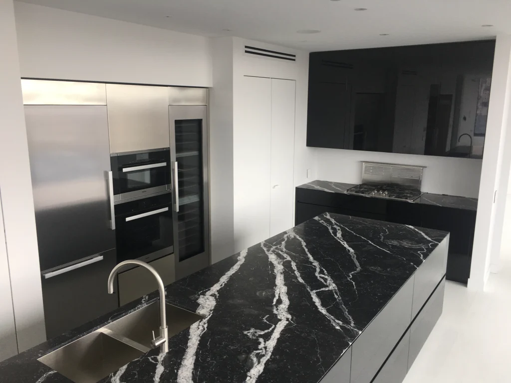 High-end appliance installation with Miele units, stainless custom panels and counter-depth appliances in Brossard.