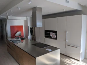 Minimalist island hood installation in bright apartment