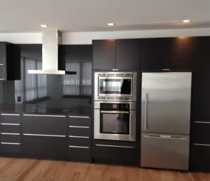 Custom oven installation in black modern kitchen