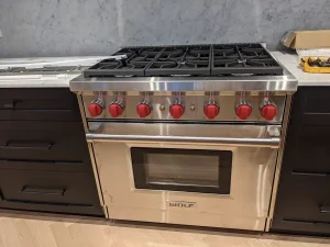 Wolf gas range oven installation with custom knobs